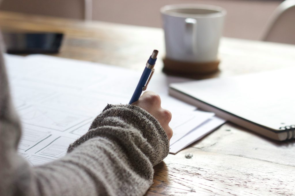 education advocacy planning checklist hand of person in gray sweater writing on papers on a desk